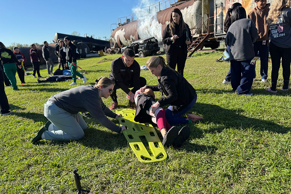 Students at the UTHealth Houston Mass Casualty Incident Training transport a 