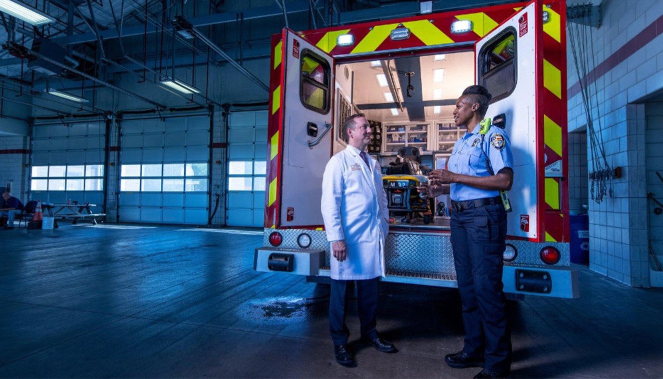 photo of Director James Langabeer II, PhD, EdD and the Heroes ambulance