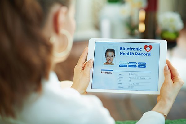 Photo of woman holding up a tablet. (Photo by Getty Images)