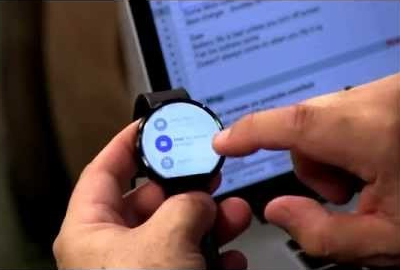 Hands touching Moto 360