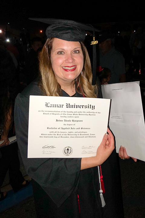 Jaime holding degree at Graduation